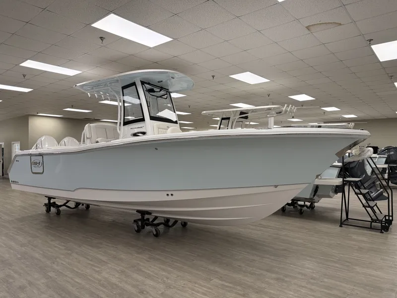 The Image of A 2027 Sea Hunt Ultra 265 SE boat is displayed in a showroom on a trailer. - 1