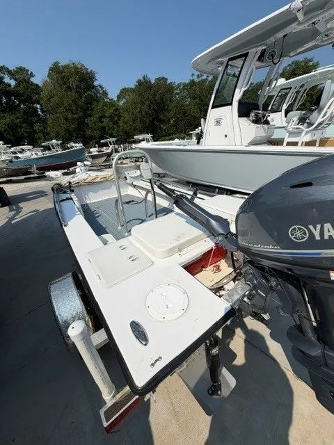 Slide: The Image of A 2024 Salt Boatworks Flats River Skiff 15 with Yamaha outboard motor, parked on a trailer. - 3