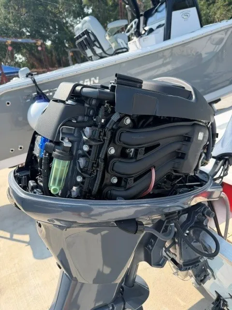 Slide: The Image of An outboard motor with its cover off reveals internal components. Another boat is visible in the background. - 13