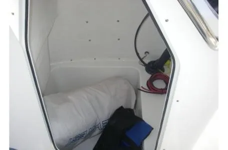 Slide: The Image of A storage compartment in the boat with a rolled-up tarp and ropes. - 5