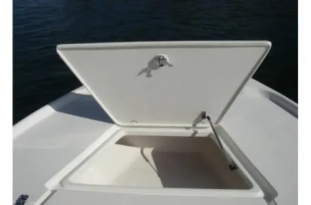 Slide: The Image of An open storage compartment on a boat, surrounded by water. - 19