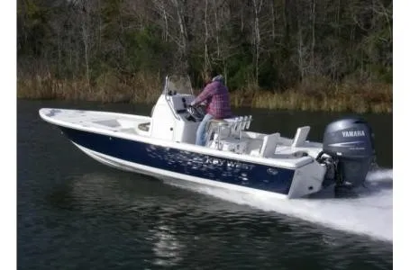 Slide: The Image of A 2021 Key West 210 Bay Reef boat cruising on calm water with a Yamaha outboard motor. - 22