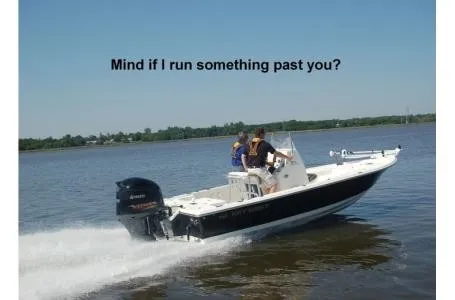 Slide: The Image of A Key West 210 Bay Reef boat speeds across the water. Two people are on board. - 18