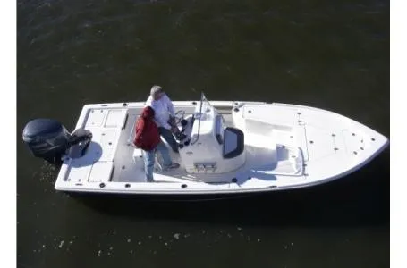 Slide: The Image of A white boat floating on calm water with two people on board. It features an outboard motor. - 20