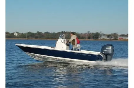 The Image of A 2021 Key West 210 Bay Reef boat cruising on calm water, powered by a Yamaha engine. - 4