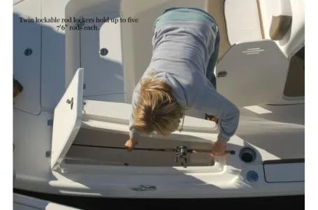 Slide: The Image of A person opens a storage compartment on a Key West 210 Bay Reef boat. - 3