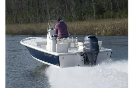 Slide: The Image of A 2021 Key West 210 Bay Reef boat on a river. Two people are on board. - 6