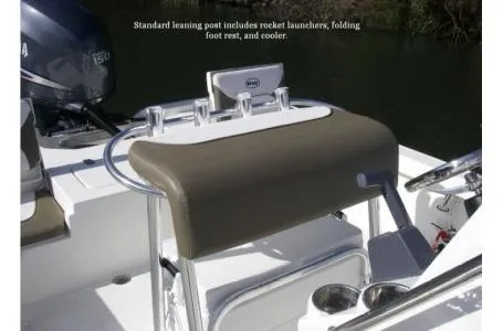 Slide: The Image of The image shows a 2021 Key West 210 Bay Reef with a standard leaning post, rocket launchers, and cooler. - 26