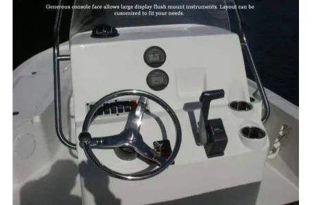 Slide: The Image of The image shows the helm of a Key West 210 Bay Reef boat with instruments and controls. - 15