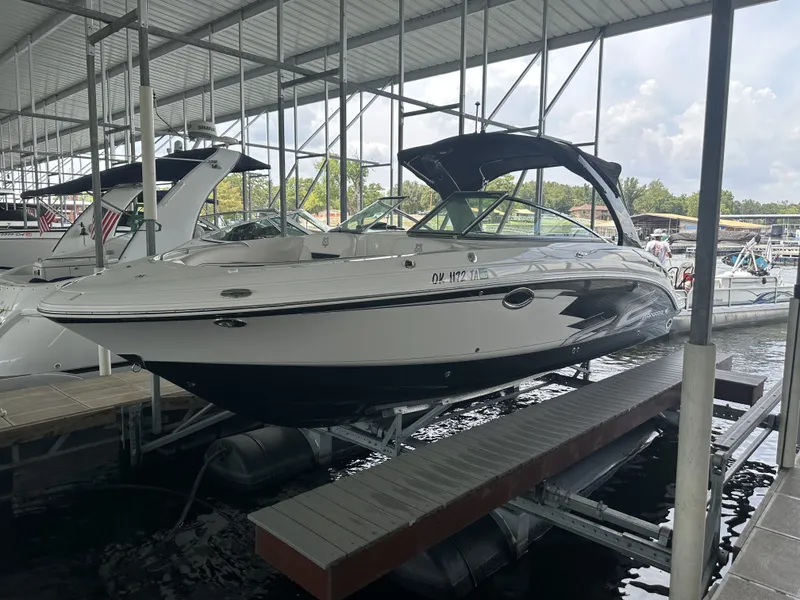 Slide: The Image of A 2011 Chaparral 287 SSX boat is docked under a covered area. It features a sleek design. - 1