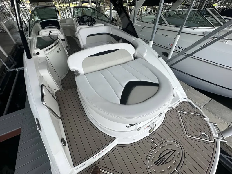 Slide: The Image of A 2011 Chaparral 287 SSX with sleek white seating and spacious deck in a marina. - 37