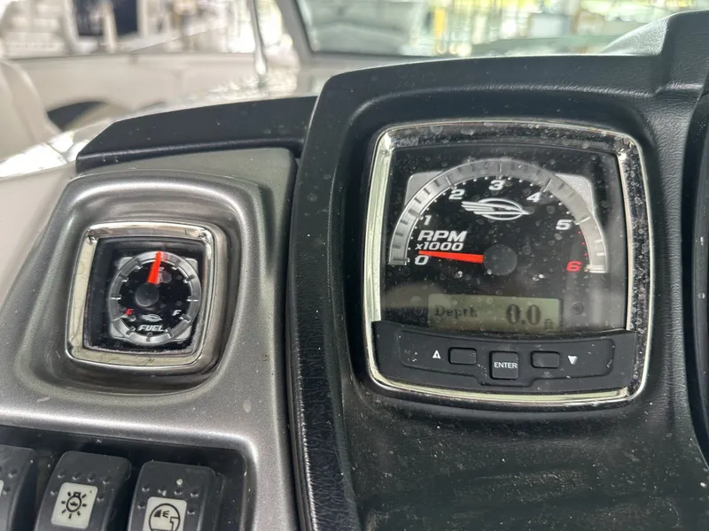 Slide: The Image of Close-up of a 2011 Chaparral 287 SSX dashboard with tachometer and fuel gauge. - 21