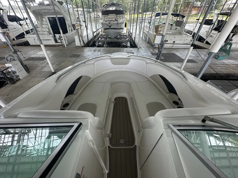 Slide: The Image of The image shows the bow of a 2011 Chaparral 287 SSX boat in a covered dock. - 29