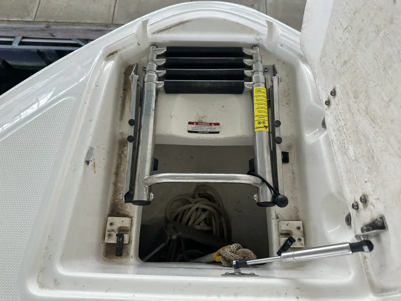 Slide: The Image of A built-in swim ladder at the bow of a 2011 Chaparral 287 SSX, with storage underneath. - 31