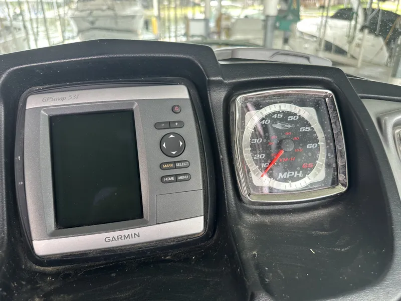 Slide: The Image of A Garmin GPSmap 531 and a speedometer are mounted on a boat's dashboard. - 22