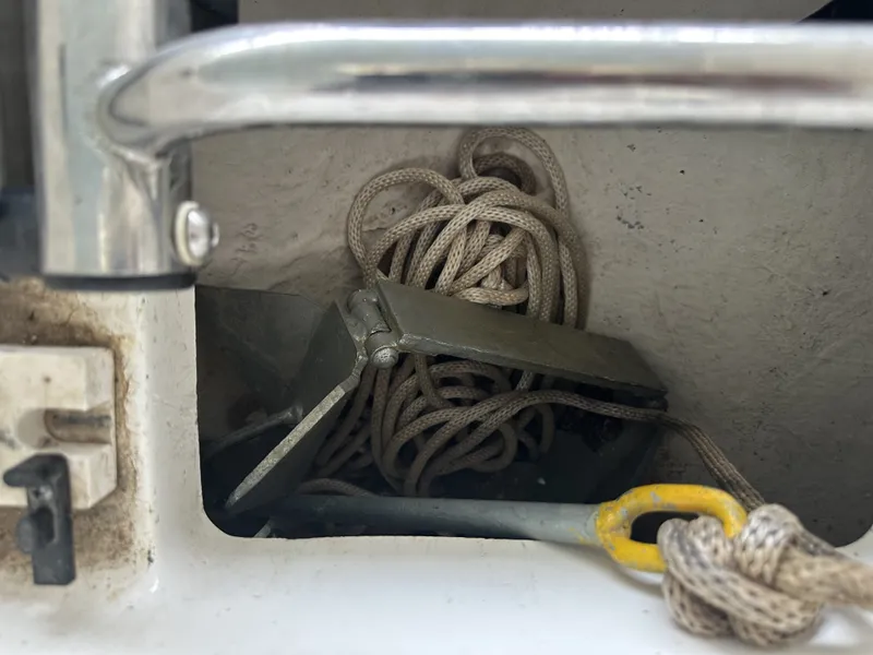 Slide: The Image of An anchor with rope is stored in a compartment on a boat. - 32