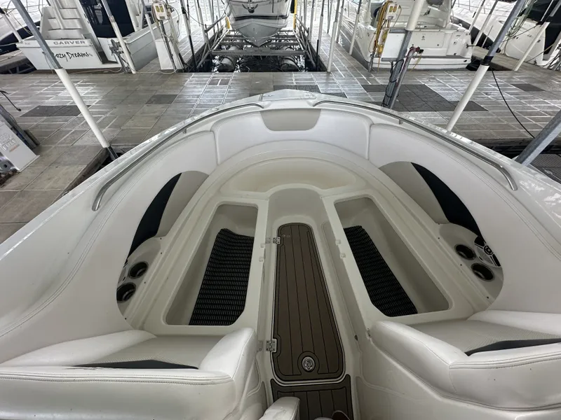 Slide: The Image of The image shows the bow of a Chaparral 287 SSX boat with white upholstery and cup holders. - 30