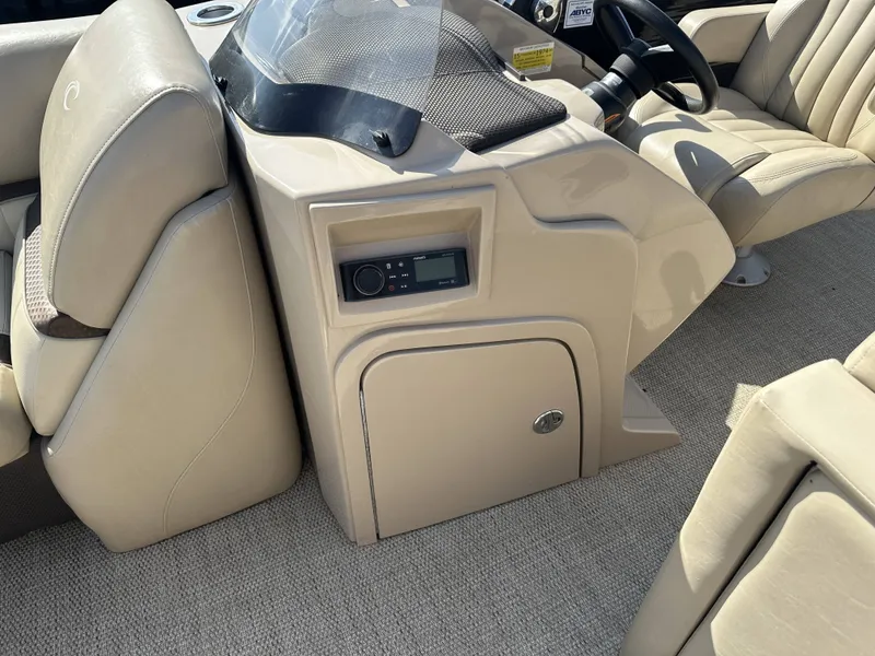 Slide: The Image of The image shows the cockpit of a 2017 Crest Classic 250SL CP3 with beige seats and a helm console. - 8