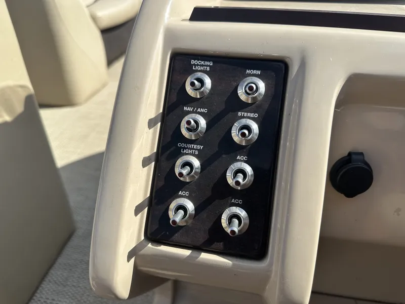 Slide: The Image of Control panel of a 2017 Crest Classic 250SL CP3 with various switches for lights and stereo. - 17
