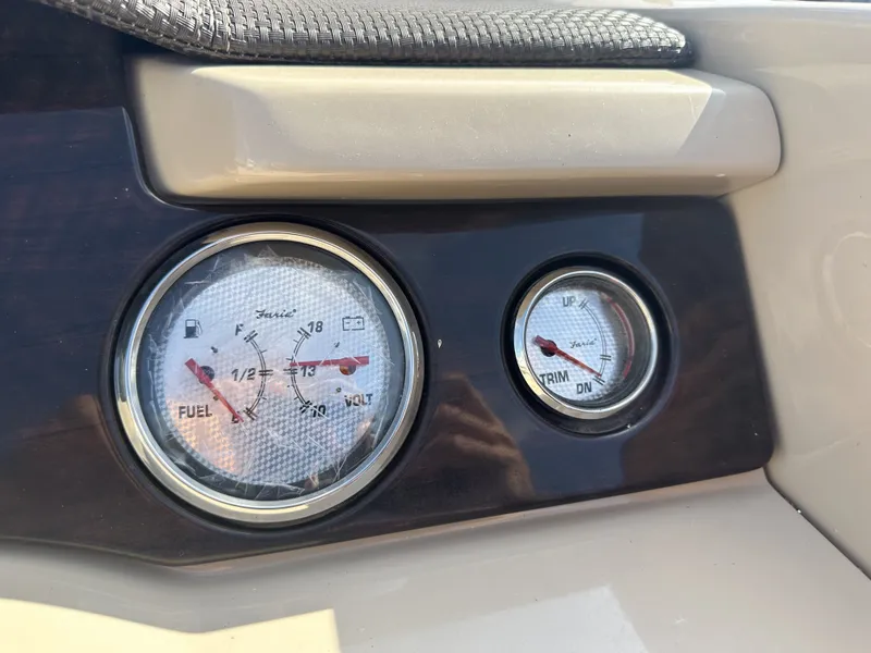 Slide: The Image of Close-up of two boat gauges showing fuel and trim levels. - 21