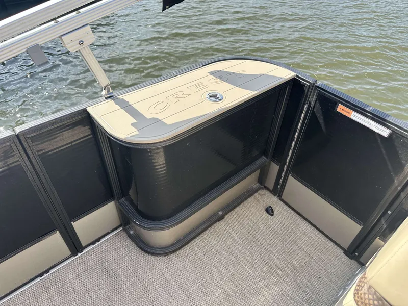 Slide: The Image of The image shows the stern of a 2017 Crest Classic 250SL CP3 pontoon boat on the water. - 14