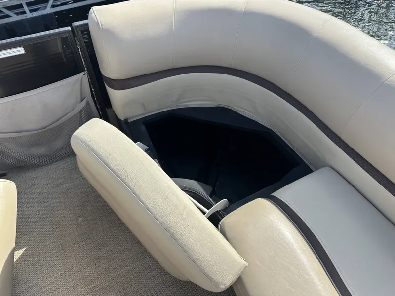Slide: The Image of A seating area on a boat with beige upholstery and storage underneath. - 5