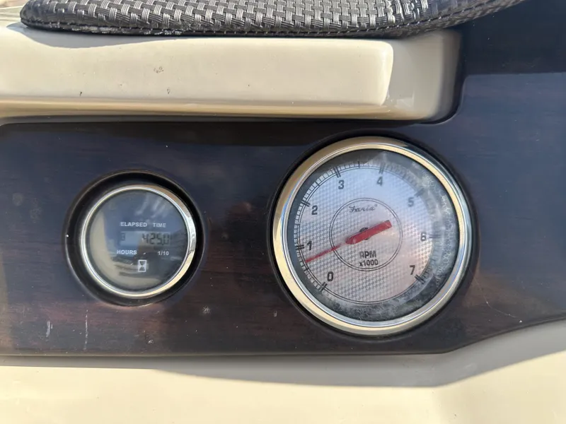 Slide: The Image of Close-up of two boat instruments, including a tachometer and an hour meter. - 18