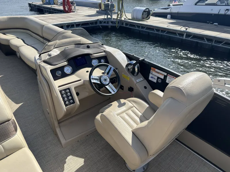 Slide: The Image of The image shows the cockpit of a 2017 Crest Classic 250SL CP3 with beige seating and controls. - 16