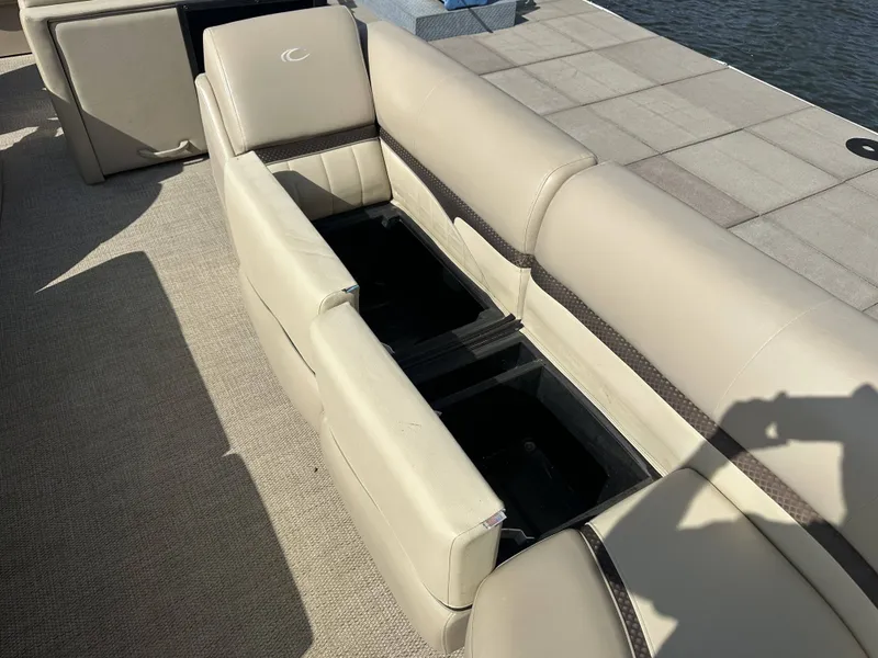 Slide: The Image of An open storage compartment beneath a beige seat on a boat. - 6