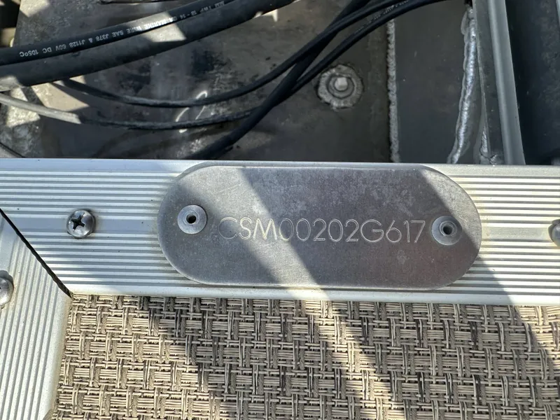 Slide: The Image of Close-up of a serial number on a boat with metal plate and woven flooring. - 28