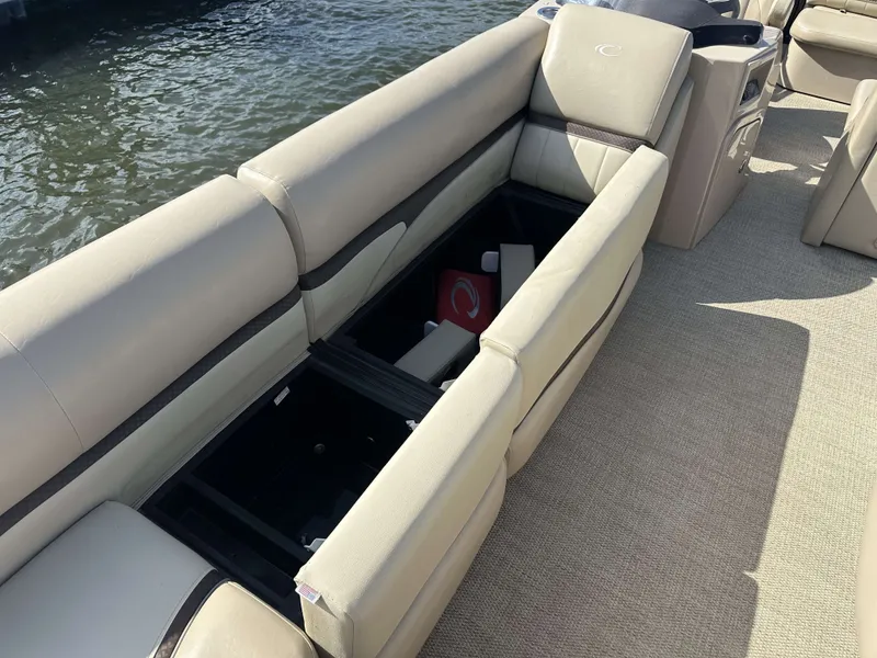 Slide: The Image of The image shows a boat's seating area with storage compartments open underneath. - 7