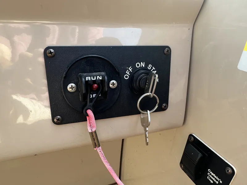 Slide: The Image of Close-up of an ignition switch with key and safety lanyard on a boat. - 22