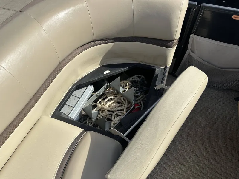 Slide: The Image of A seating area on a boat with an open storage compartment containing ropes. - 4