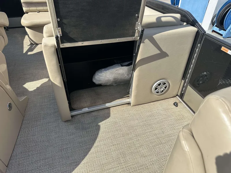 Slide: The Image of Interior of a 2017 Crest Classic 250SL CP3 with beige carpet and storage space. - 29