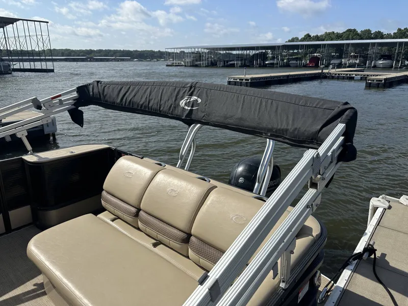 Slide: The Image of A 2017 Crest Classic 250SL CP3 pontoon boat with beige seats and black sunshade by the water. - 25
