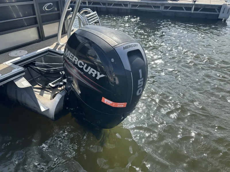 Slide: The Image of A Mercury 150 outboard motor on a Crest Classic 250SL CP3 boat, in water at the dock. - 27