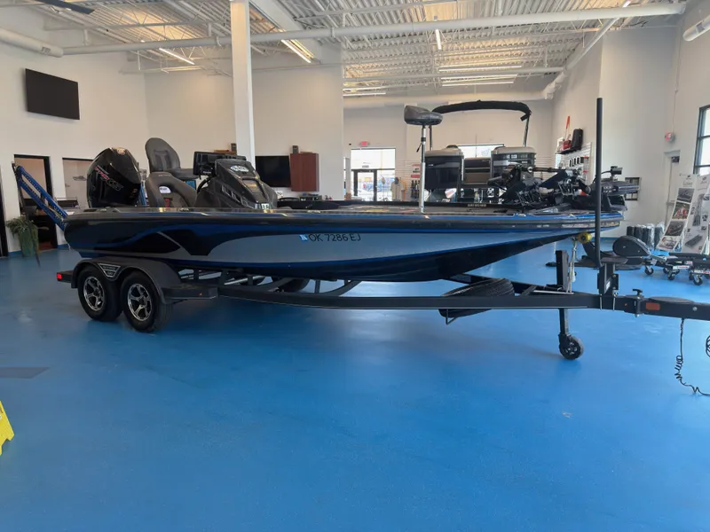 Slide: The Image of A 2023 Nitro Z20 boat is in a showroom. It features a trailer and an outboard motor. - 3