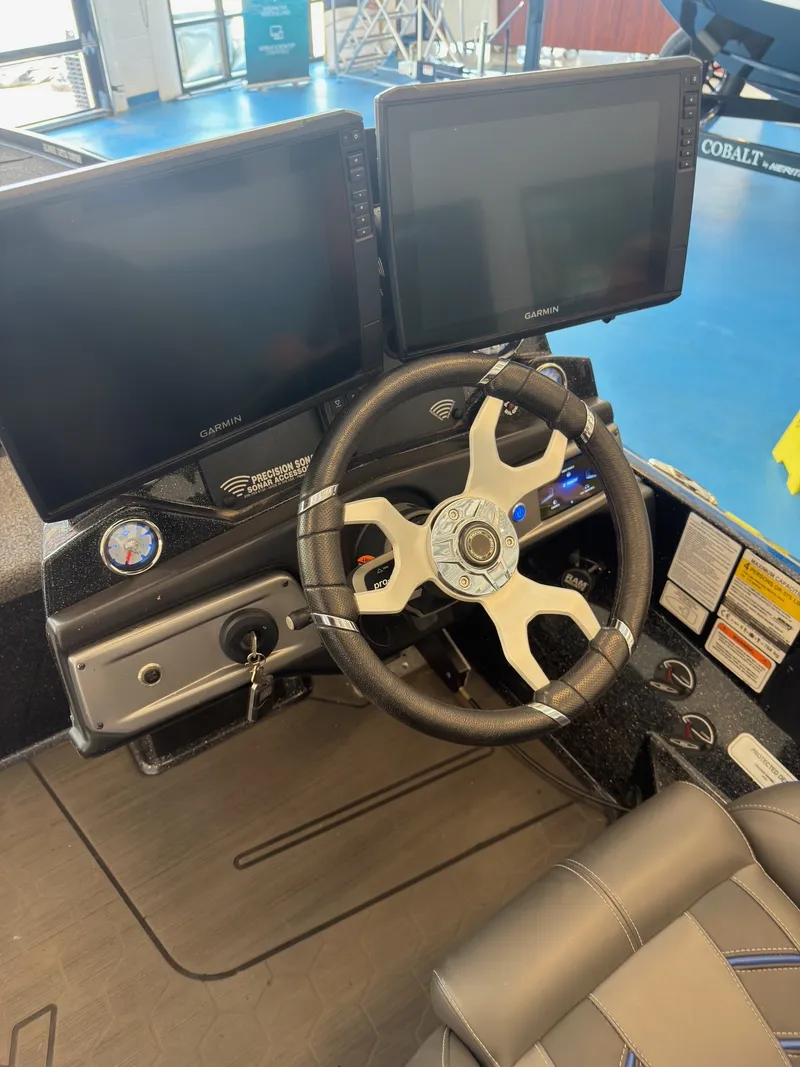 Slide: The Image of The image shows the cockpit of a 2023 Nitro Z20 boat with two large Garmin screens and a modern steering wheel. - 23