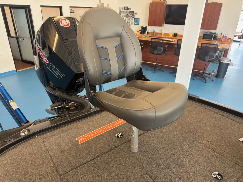 Slide: The Image of A gray boat seat with blue stitching on a 2023 Nitro Z20, inside a building. - 12