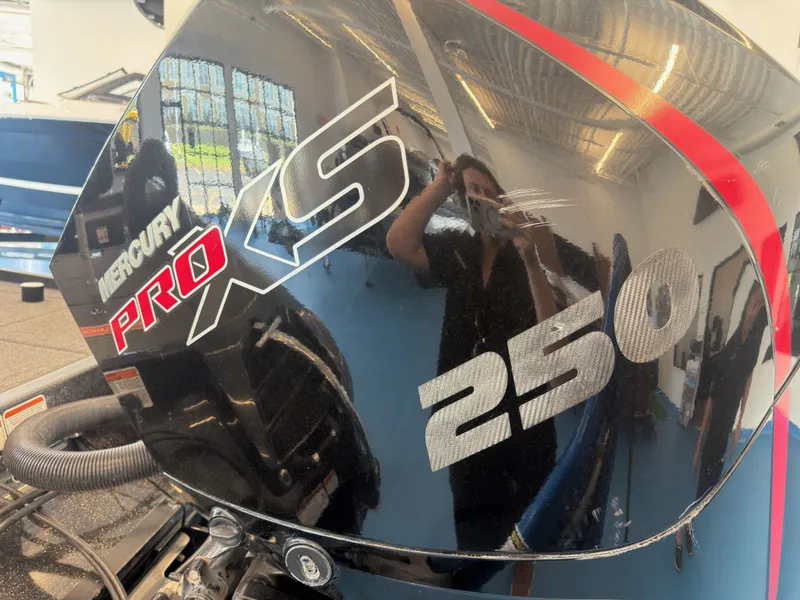 Slide: The Image of Close-up of a Mercury Pro XS 250 outboard motor mounted on a boat. - 18