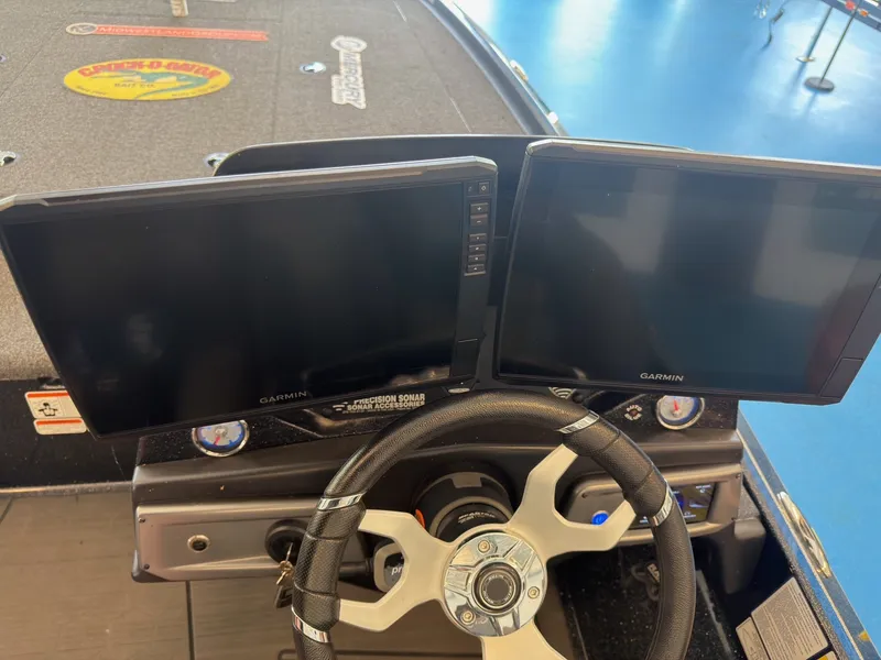Slide: The Image of The image shows the cockpit of a Nitro Z20 boat with two Garmin screens and a steering wheel. - 9