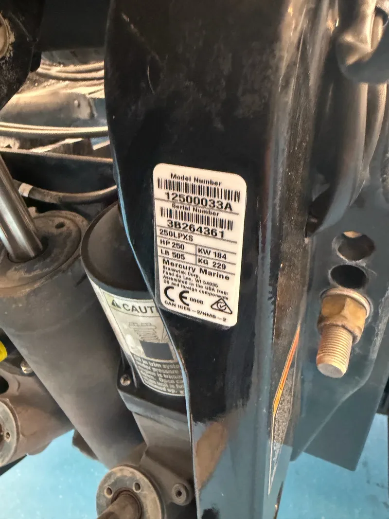 Slide: The Image of Close-up of a boat outboard motor with technical details on a sticker. - 31