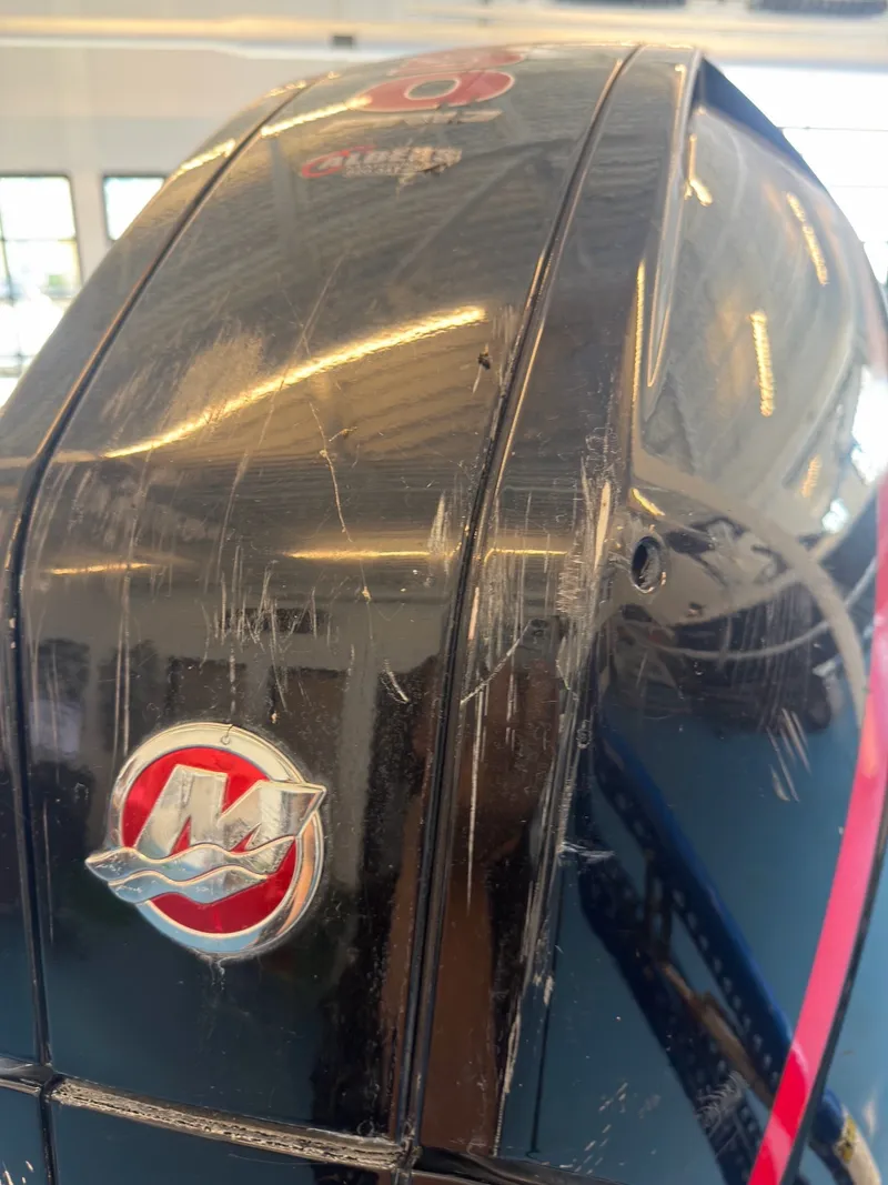 Slide: The Image of Close-up of a scratched Mercury outboard motor mounted on a boat. - 29