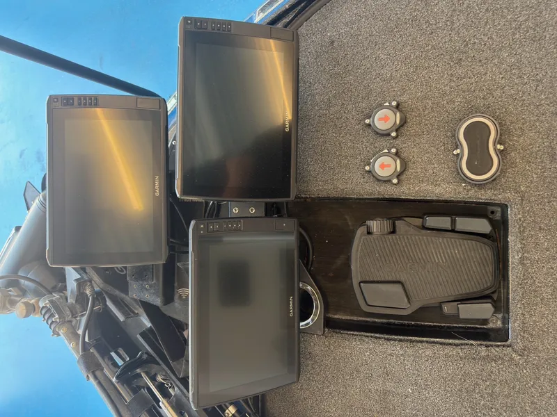 Slide: The Image of Three black screens and pedals on a gray floor, likely inside a boat. - 24