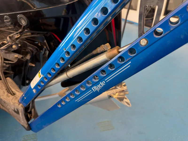 Slide: The Image of Close-up of a blue boat frame labeled "Blade." Metal components and screws are visible. - 16