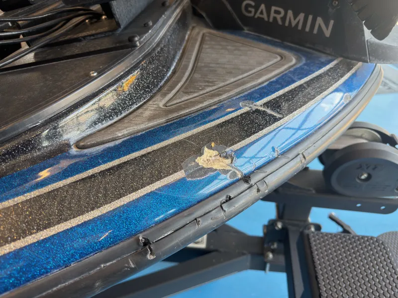 Slide: The Image of Close-up of a blue Nitro Z20 boat with scratches and wear on the edge. - 30