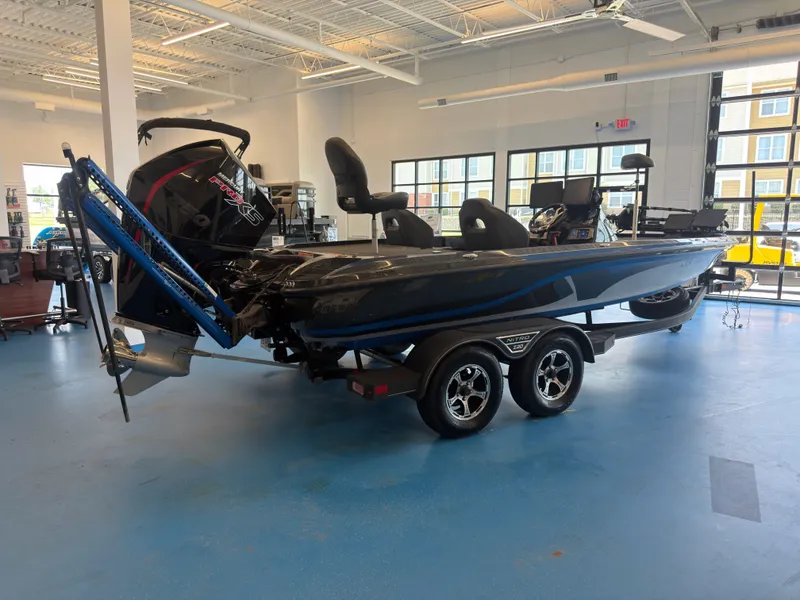 Slide: The Image of A 2023 Nitro Z20 boat is in a showroom. It features a powerful outboard motor. - 4