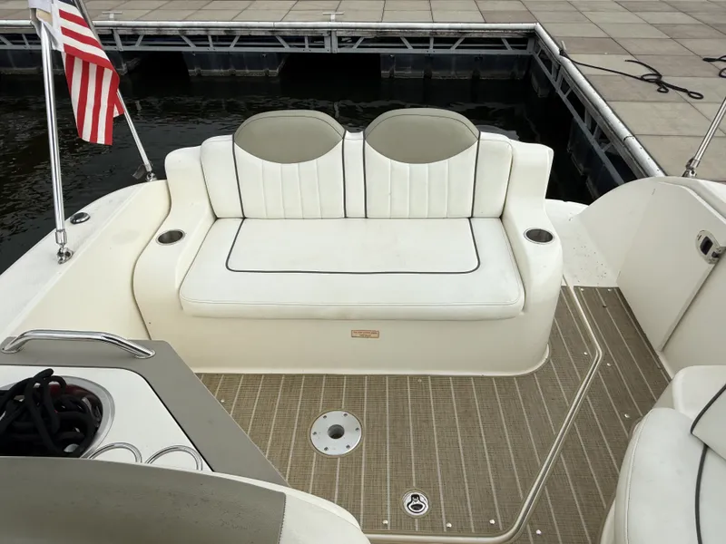 Slide: The Image of The image shows the cockpit of a 2007 Sea Ray 240 Sundancer with a white bench seat. - 4