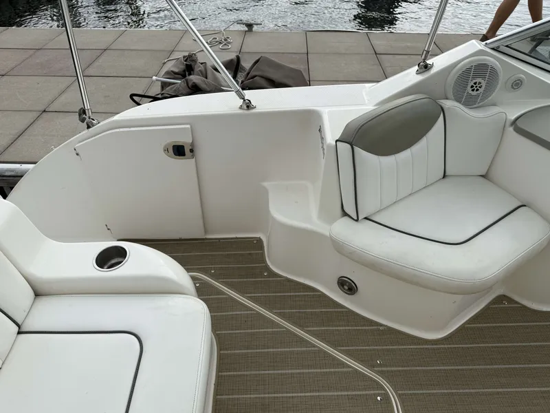 Slide: The Image of The image shows the cockpit of a 2007 Sea Ray 240 Sundancer with white upholstery. - 6