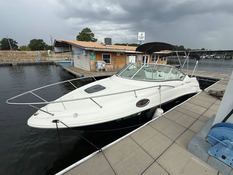 The Image of A white 2007 Sea Ray 240 Sundancer docked. The sky is overcast. - 1